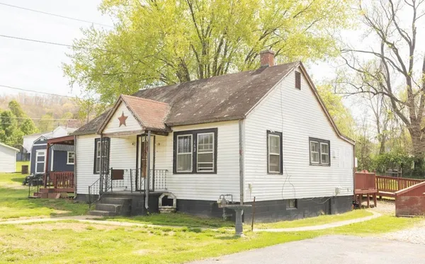a view of a house with pool and chairs
