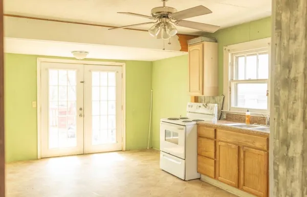 a view of a kitchen with appliances cabinets and a sink