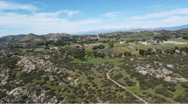 an aerial view of residential house with green space
