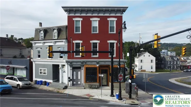 a front view of a building and car parked