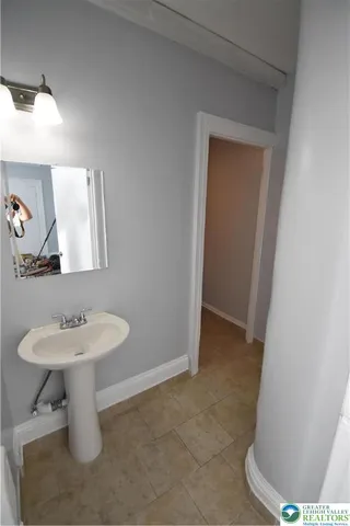 a kitchen with a stove a sink and a window