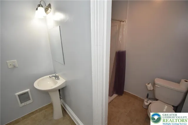 a kitchen with granite countertop a sink cabinets and stainless steel appliances