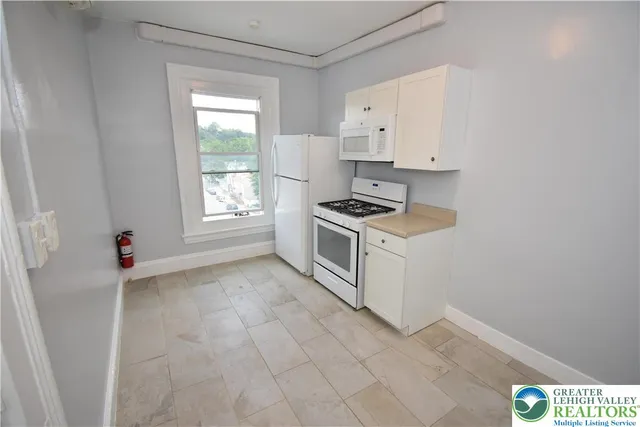 a kitchen with stainless steel appliances a stove a sink and cabinets