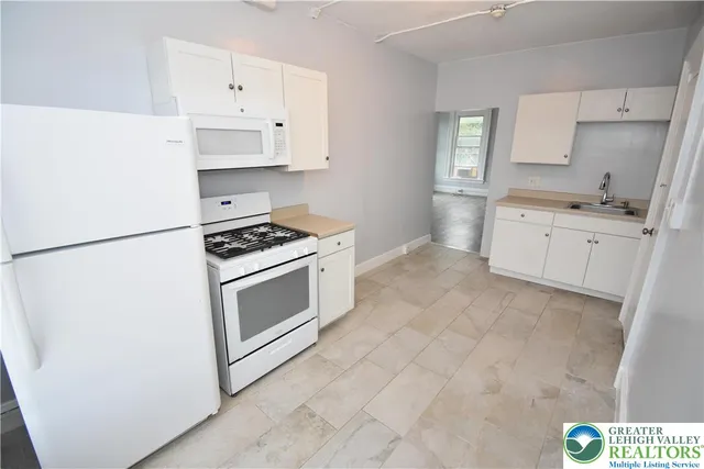 a view of room with hardwood floor and cabinet