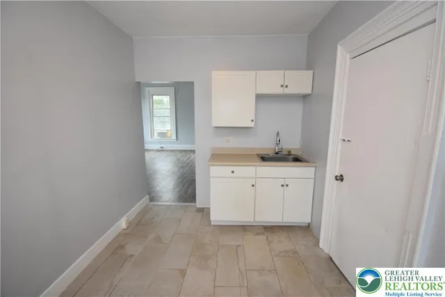 a bedroom with bed and a window