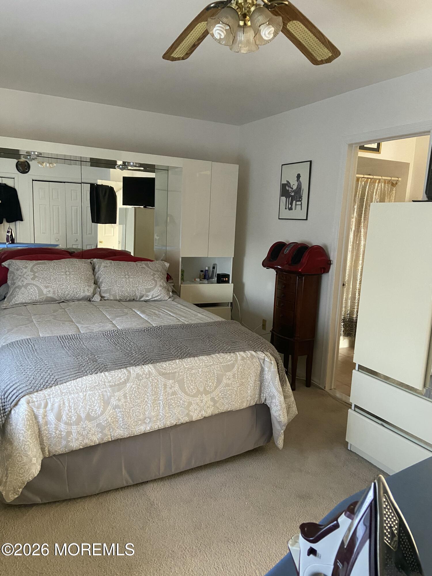 190 Spruce Street, Unit 5 Long Branch, NJ 07740 - Photo 5 of 12 a bedroom with a bed and a refrigerator