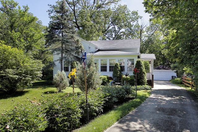 1129 Shermer Road Glenview, IL 60025 - Photo 1 of 3 a view of a house with a chairs and table in a patio