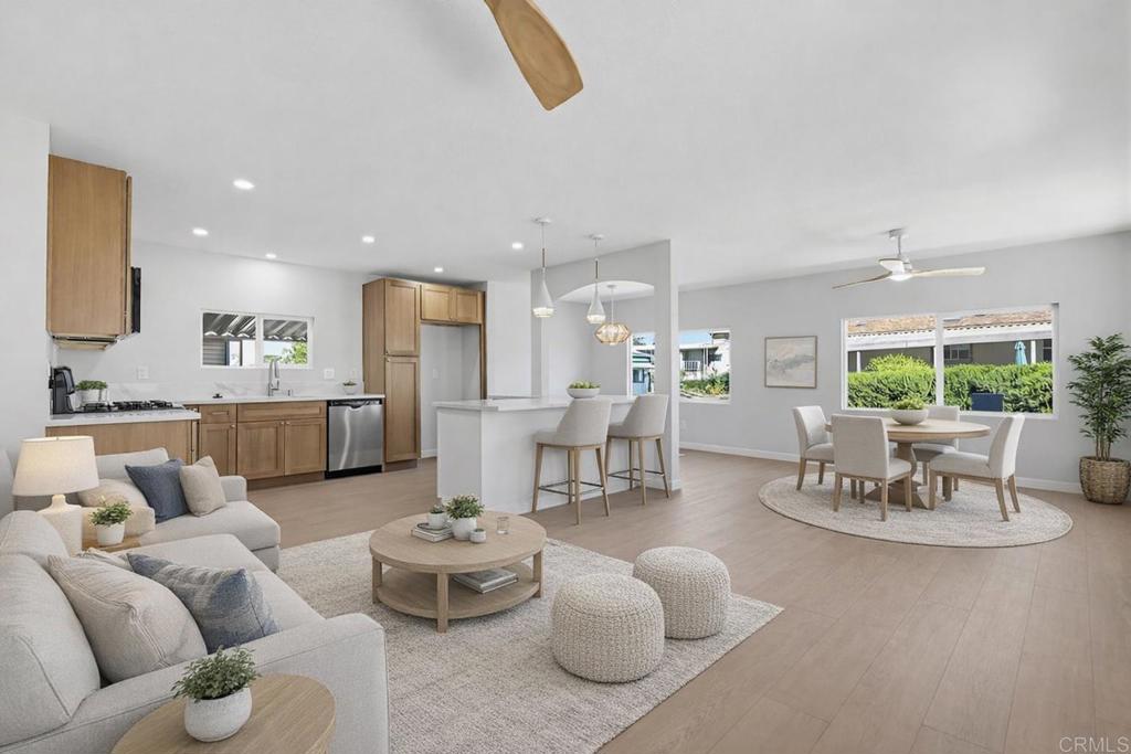 a living room with furniture kitchen view and a table