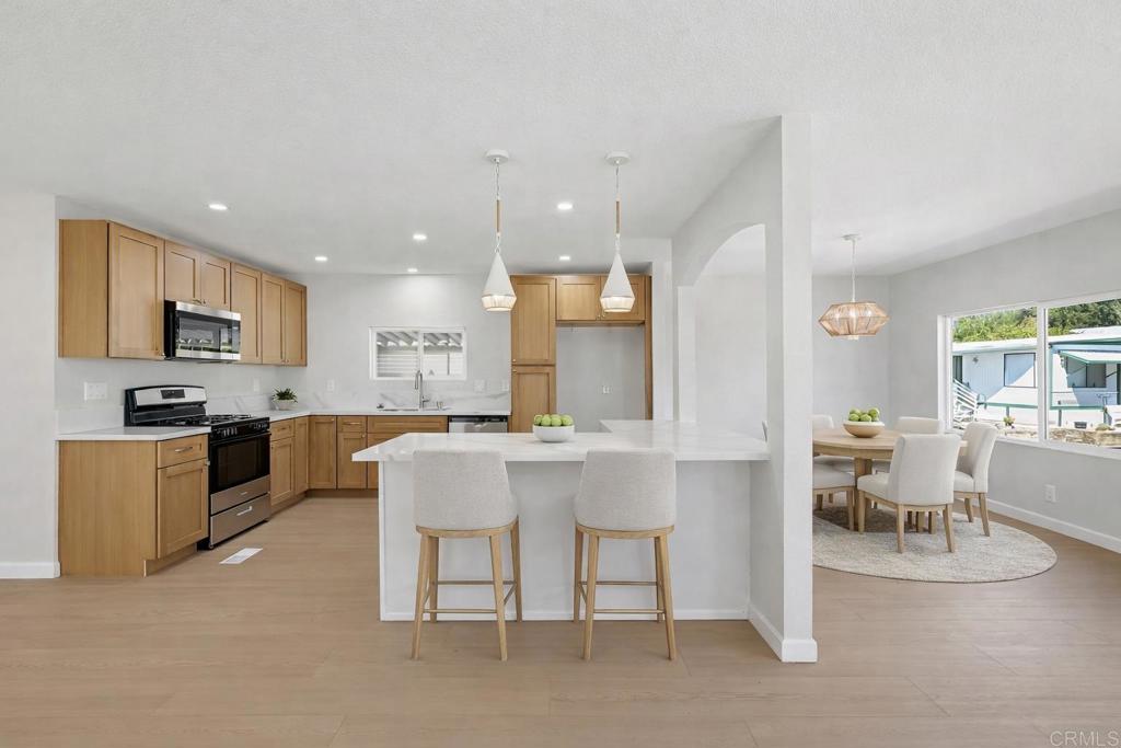 2400 Alpine Boulevard, Unit 8 Alpine, CA 91901 - Photo 4 of 19 a kitchen with stainless steel appliances kitchen island granite countertop a sink and cabinets