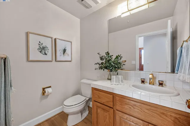 a kitchen with stainless steel appliances granite countertop a table chairs sink refrigerator and cabinets