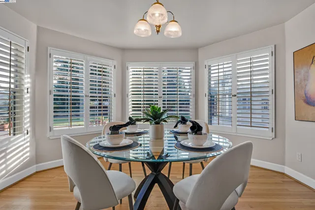a bathroom with a sink a mirror and a bathtub next to a window