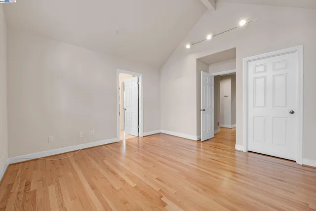 a spacious bedroom with a bed and a couch