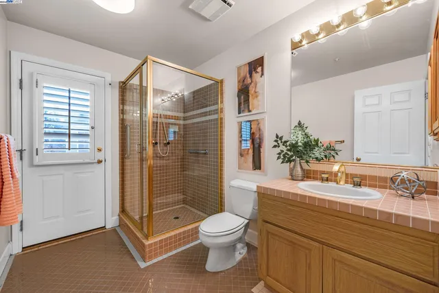 a front view of a house with a garden and lake view