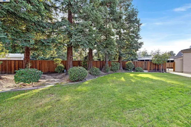 an aerial view of a house with a swimming pool patio and outdoor seating