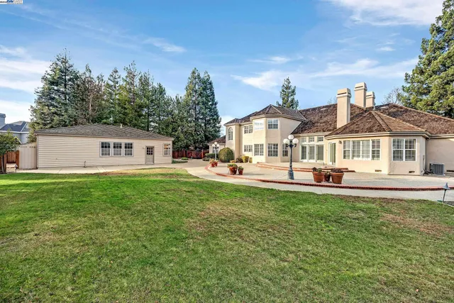 an aerial view of a house with table and chairs