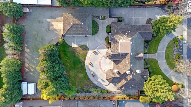 a front view of a house with a garden and yard