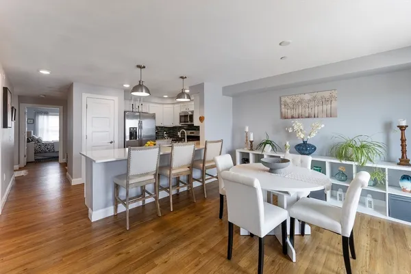 a view of a dining room with furniture and wooden floor