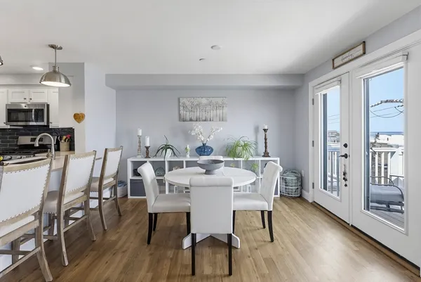 a view of a dining room with furniture and wooden floor