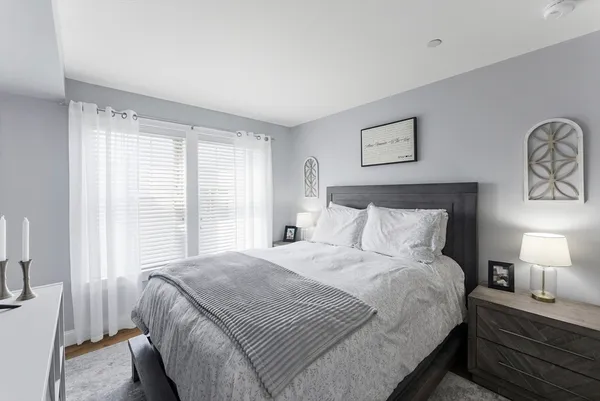 a bedroom with a bed and a night stand