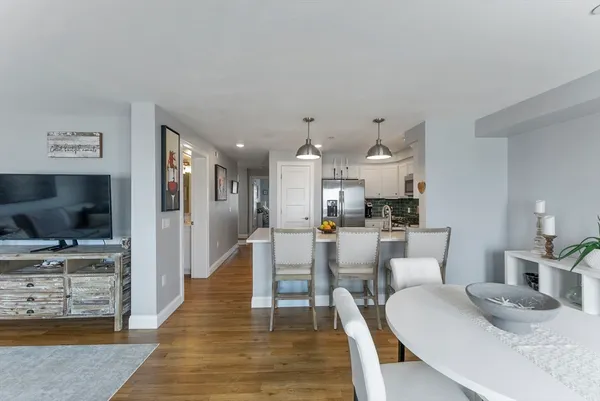 a dining room with furniture and wooden floor