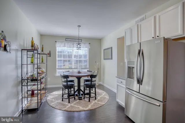 a view of a dining room with furniture and a chandelier