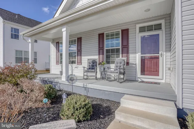a front view of a house with outdoor seating and plants