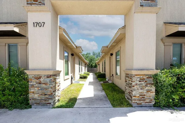 a view of a pathway along with potted plants