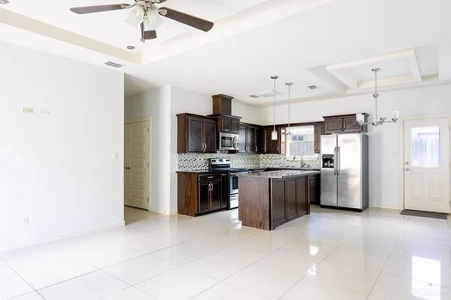 a large kitchen with cabinets and stainless steel appliances