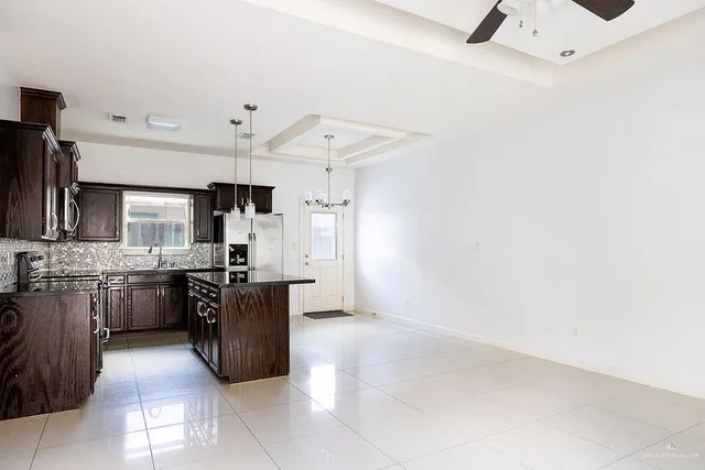 a large kitchen with cabinets and stainless steel appliances
