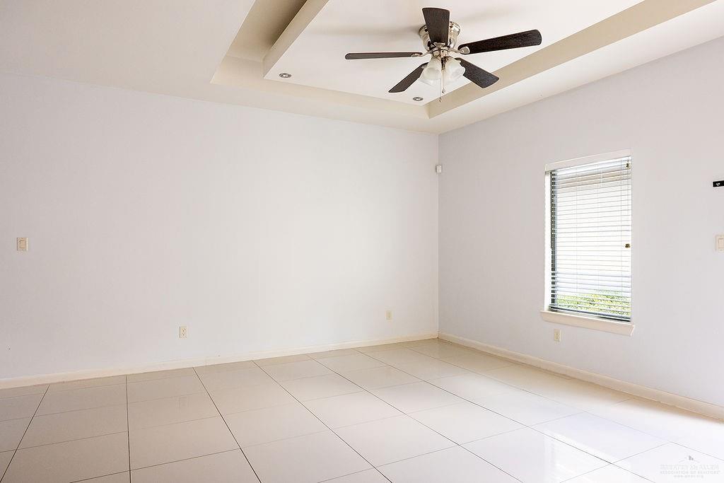 1707 West Smith Drive, Unit 2 Pharr, TX 78577 - Photo 6 of 14 an empty room with windows and fan