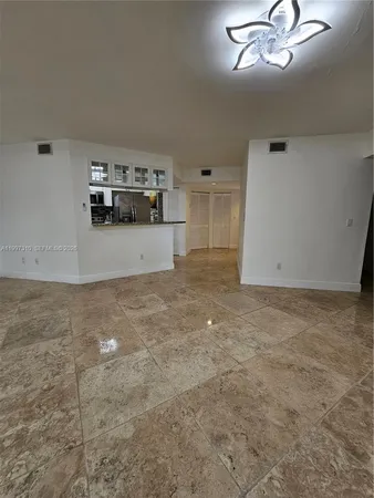 an empty room with a empty space and windows