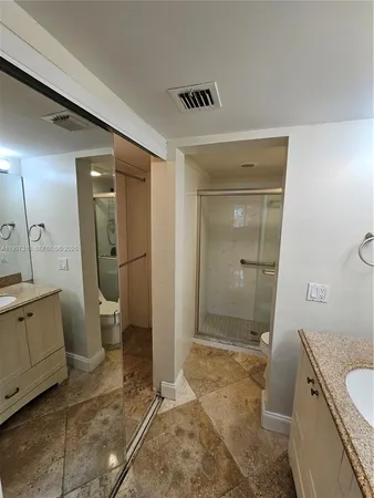 a bathroom with a shower and a mirror
