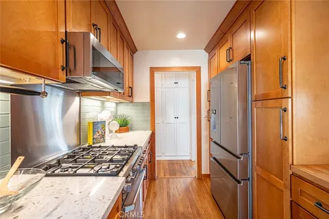 a kitchen with stainless steel appliances granite countertop a refrigerator and a sink