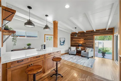 a kitchen with a sink a window and chairs