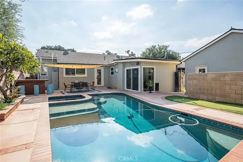 a view of a house with swimming pool and sitting area