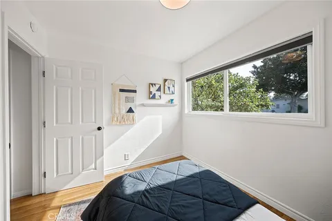 a view of a bedroom with furniture and windows