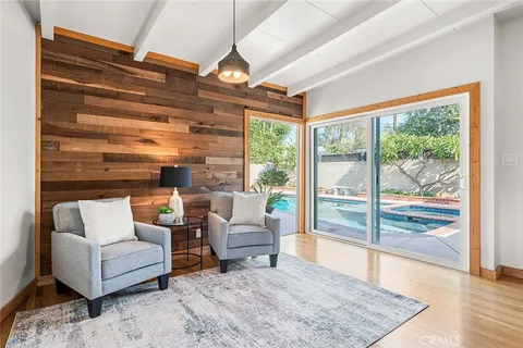 a living room with furniture and a floor to ceiling window