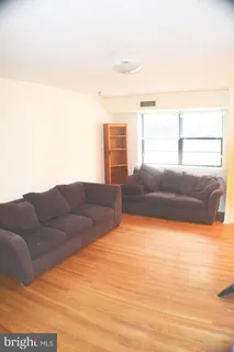 a living room with a couch and a dresser