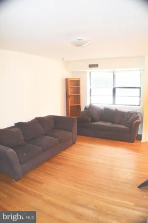 a living room with a couch and a dresser