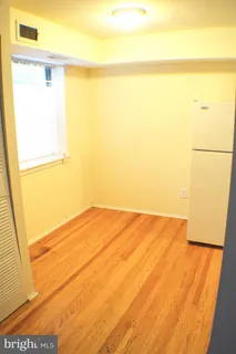 a view of an empty room and a window