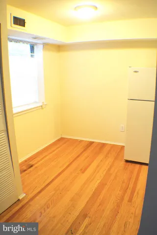 a view of an empty room and a window