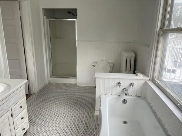 a bathroom with a bathtub sink and window