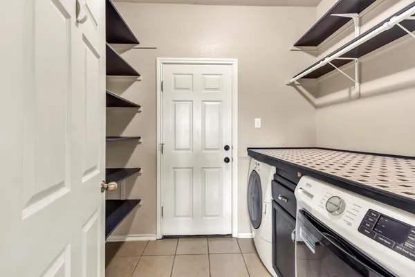 walk in closet with wooden floor washer and dryer