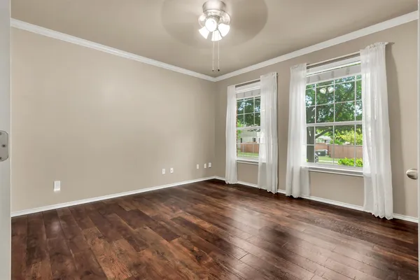 wooden floor in an empty room with a window