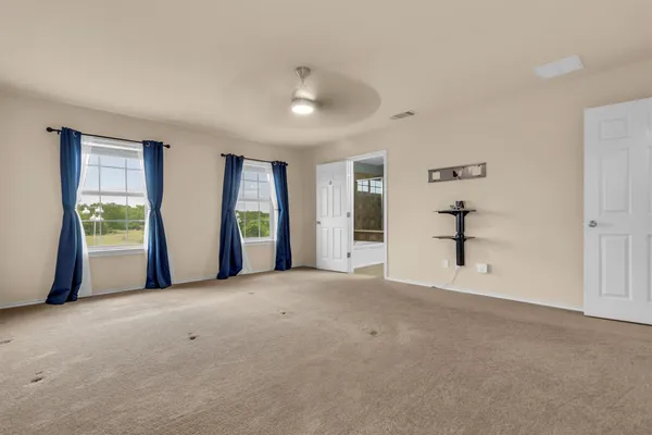 an empty room with windows and closet