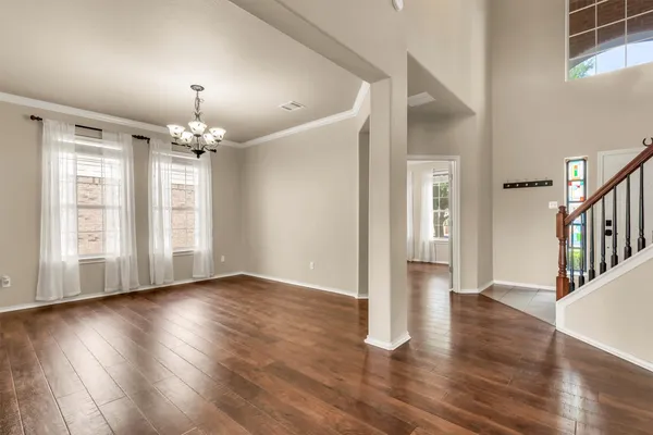 a view of a livingroom with wooden floor and chandelier