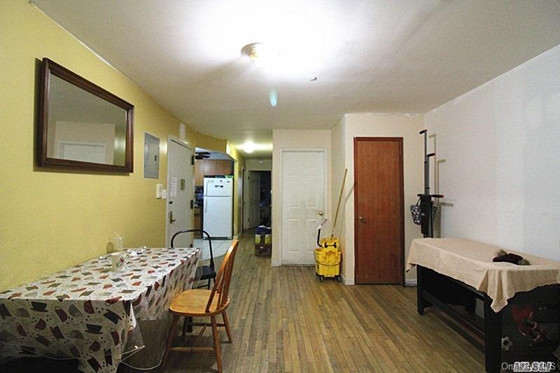 104-48 38th Avenue Queens, NY 11368 - Photo 4 of 9 a view of a dining room with furniture and wooden floor