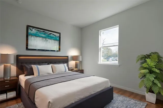 a bedroom with a bed and a painting on the wall