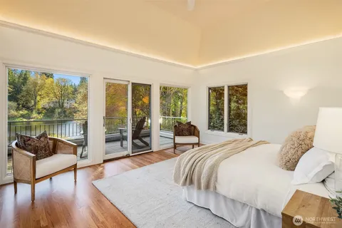 a bedroom with a bed and glass window