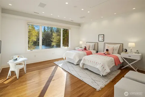 a bedroom with a bed and a large window